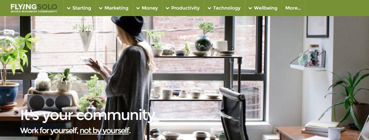 Flying Solo micro business community homepage with hero image of woman reading a tablet in a plant-filled studio