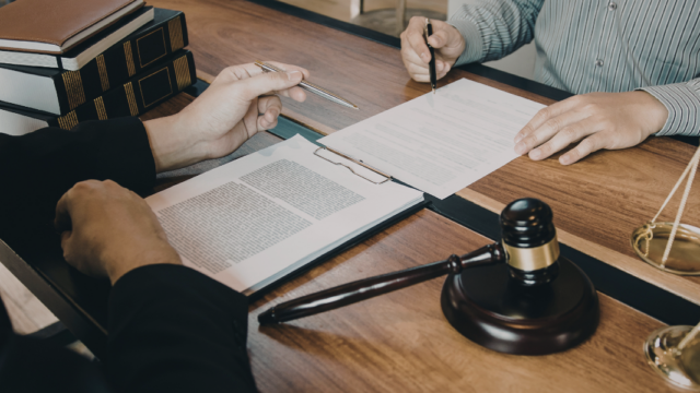 Two people reviewing legal documents
