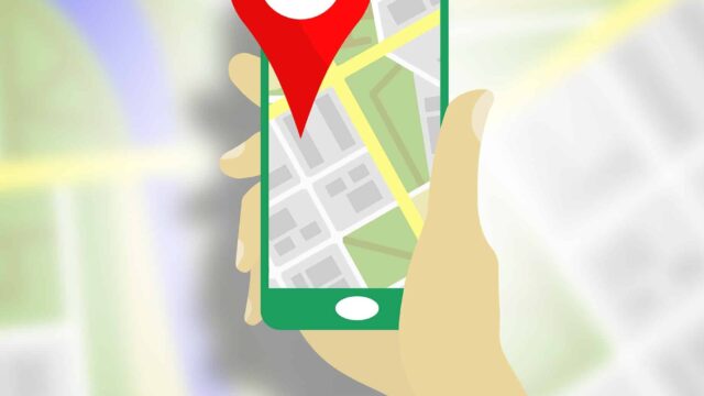 Illustrated hand holding a smartphone with a map pin on a street map, representing local SEO