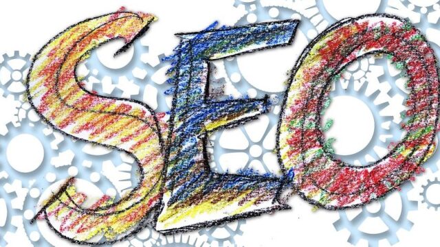 Colourful crayon-style letters spelling SEO against a background of grey gear wheels